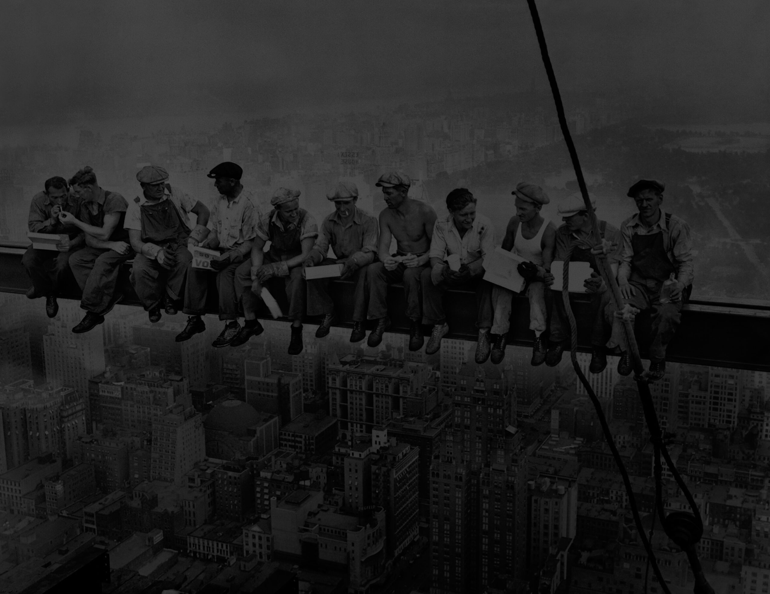 Famous photo titled, "Lunch atop a Skyscraper" which is a black-and-white photograph taken on September 20, 1932, of eleven ironworkers sitting on a steel beam of the RCA Building, 850 feet (260 meters) above the ground during the construction of Rockefeller Center in Manhattan, New York City.